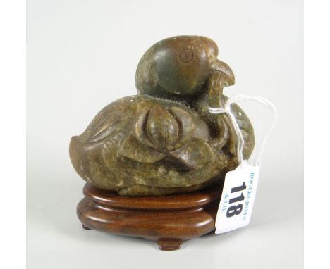 CHINESE SPINACH JADE STUDY OF A BIRD with finely incised wings to either side, modelled holding a lotus leaf vine in mouth, r