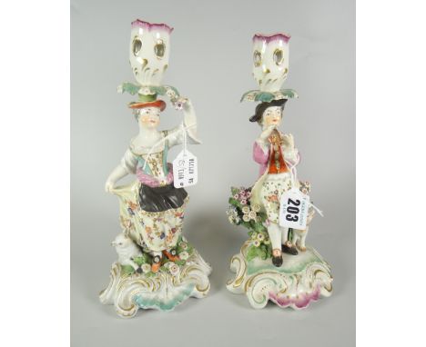 PAIR OF 19th CENTURY PORCELAIN FIGURAL CANDLESTICKS depicting male &amp; female with flowers &amp; animals on naturalistic sc
