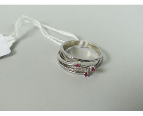 18CT WHITE GOLD DIAMOND CHIP AND RUBY RING of spiral three prong design, 3.6 grams, in box. Condition Report: Appears in good