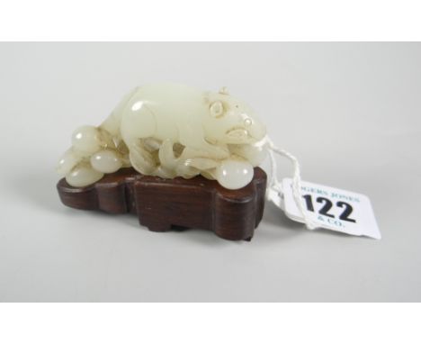 BELIEVED CHINESE JADE CARVED STUDY OF A RAT on naturalistic base raised on hardwood stand, 5cms high Condition Report: appear