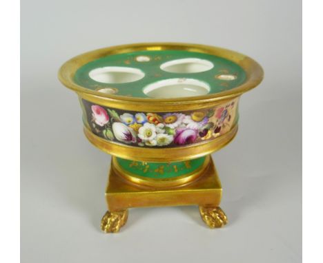 A NINETEENTH CENTURY PORCELAIN INKSTAND in green ground with gilding and of pedestal form with circular body over a square ba