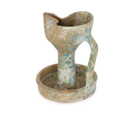 A turqoise glazed pottery oil lamp, Kashan, Persia, 12th century, on a circular base with everted lip, with tubular stem lead