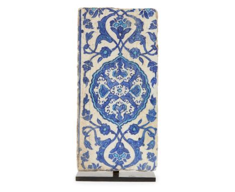 A blue and white Iznik pottery border tile, Ottoman Turkey, circa 1530, of rectangular form, the surface painted in cobalt-bl