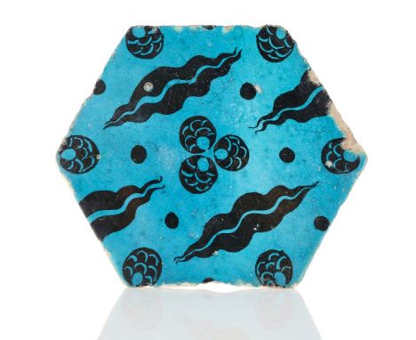 A hexagonal Cintimani tile, Ottoman Syria, 16th century, painted in black under a transparent glaze, 29cm. highProvenance: Th