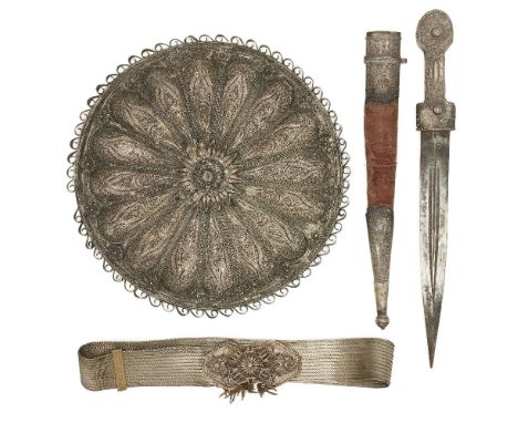 An Ottoman silver filigree circular mirror, a dagger, and a silvered filigree belt, Turkey, late 19th-early 20th century, the