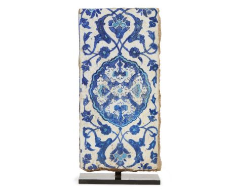 A blue and white Iznik pottery border tile, Ottoman Turkey, circa 1540, of rectangular form, the surface painted in cobalt-bl