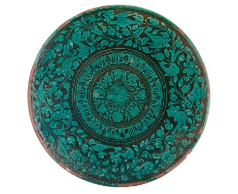 A blue and white pottery tile in the Iznik style, late 19th-early 20th century, of rectangular form, with design of scrolling