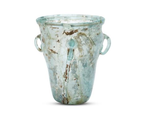 A Byzantine pale bluish-green glass hanging lamp, 6th-7th century, with three loop suspension handles to shoulder, 11cm. high