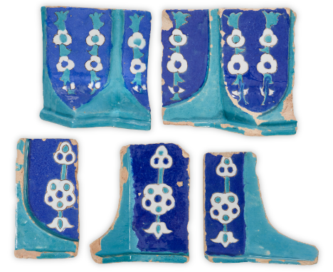 Five Timurid cuerda seca tile fragments from a spandrel archway, Persia, 15th century, underglaze painted in turquoise, cobal