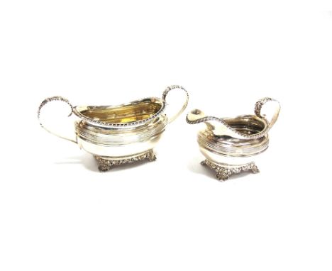 A GEORGIAN SILVER CREAM JUG AND SUGAR BASIN by Rebecca Emes & Edward Barnard, London 1825, of rounded rectangular form, gadro