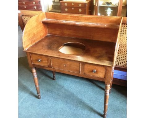A WILLIAM IV MAHOGANY WASHSTAND  the gallery with shelf, the top with circular recess for washbasin, faux drawer flanked by t