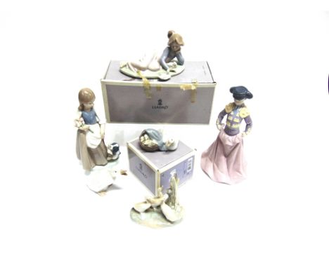 A GROUP OF LLADRO AND NAO  including Lladro 6438 'Young Torero' (head re-glued), Lladro 5609 'Playful Friends' (boxed) and fo