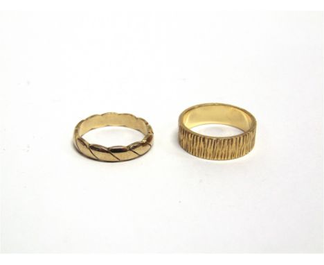 AN 18 CARAT GOLD WEDDING RING with a light bark effect, finger size M1/2, 5.1g gross; with a 9 carat gold wedding ring, finge