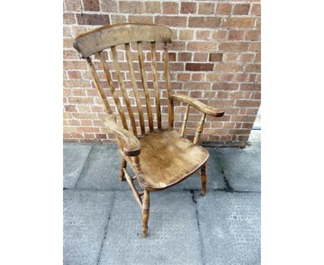 AN ELM SEAT COMB BACK WINDSOR ARMCHAIR  on turned supports with double H-shape stretcher base