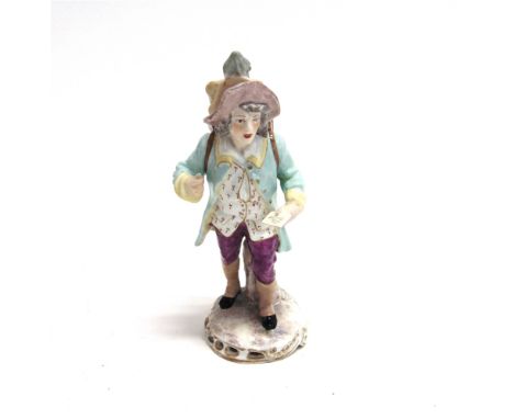 A CONTINENTAL HARD PASTE PORCELAIN FIGURE modelled as a man carrying a magic lantern, underglaze blue mark to base, 16cm high