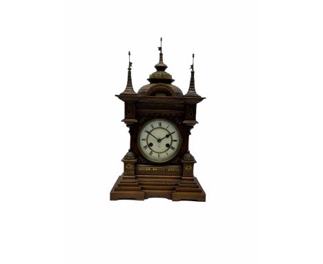 A late 19th century German Black Forrest mantle clock striking the hours and half hours on a coiled gong, two-piece white ena