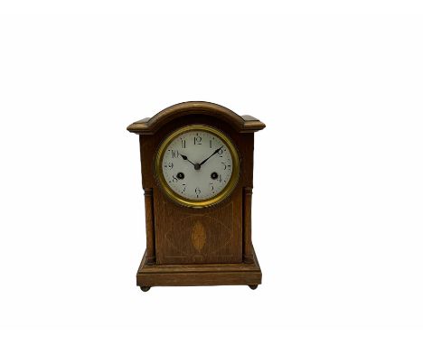 An early 20th century eight-day German (Junghans) mantle clock, Oak case with a moulded plinth on four bun feet, turned woode