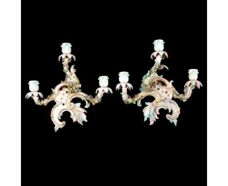 Pair of Continental porcelain three-light wall candelabra, Meissen mark to one, floral encrusted rococo style, width 30cm, he