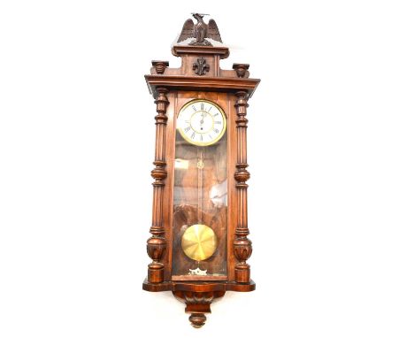 Vienna walnut wall clock, eagle pediment, glazed door, single weight movement non-striking, approximately 132cm.Condition rep