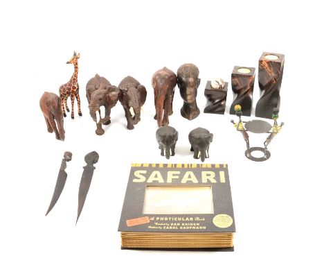 Collection of carved African figures, elephants, trio of candlestands, and a photicular book 'Safari' by Carol KaufmannQty: 1