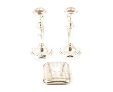 Pair of small silver candlesticks, Birmingham 1972, filled, 14.5cm and a silver cigarette case, 2.75oz.Qty: 3