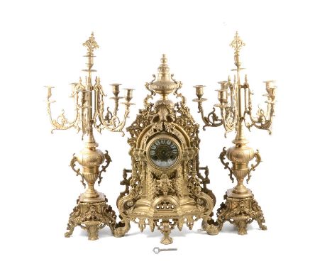 Large French cast brass clock garniture, the clock with vase surmount, the German cylinder movement striking on a bell, 60cm,