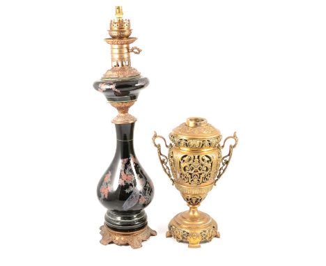 Cast brass oil lamp base, pierced body, twin handles, lacking burner section, 35cm, and a Victorian style oil lamp, black cer