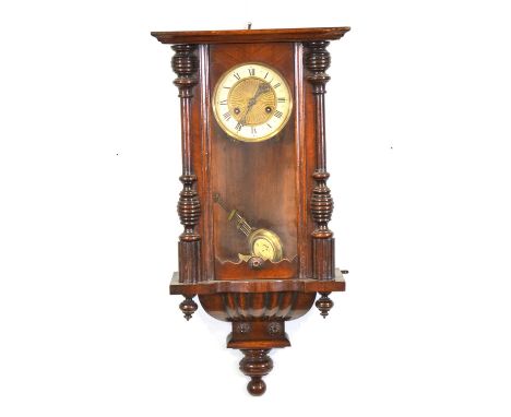 Walnut cased Vienna wall clock, eagle pediment, spring-driven movement striking on a gong, 90cm.