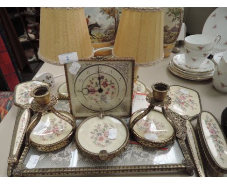 A dressing table set with machine tooled brass work, including clock candlestick and lamp pair