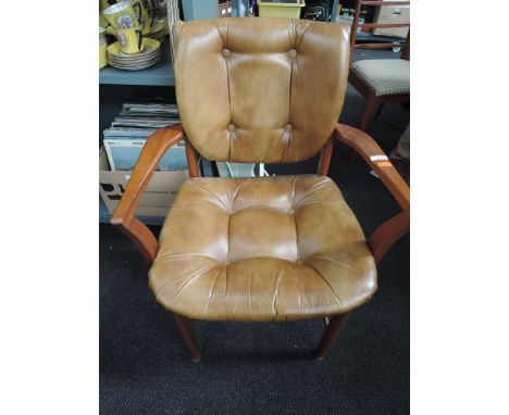 A vintage teak and leatherette carver chair