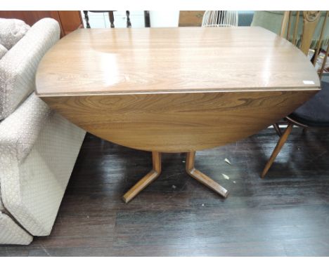 A mid to dark stain Ercol drop leaf dining table