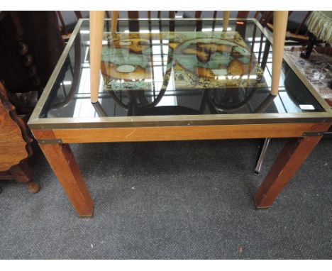 A vintage glass top coffee table with world map design 