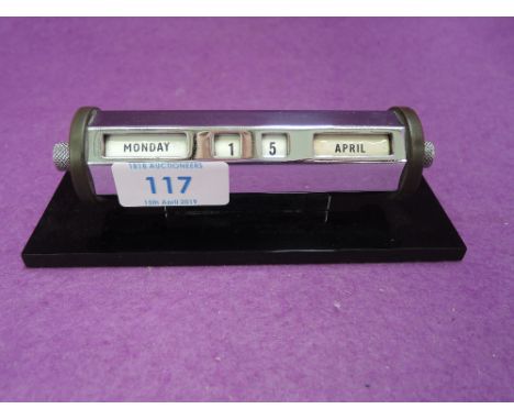 An Art Deco desk top perpetual revolving date calendar with enamel dials