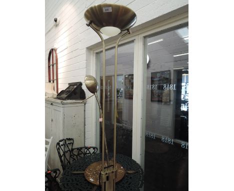 A modern brushed brass effect, uplighter/reading style standard lamp