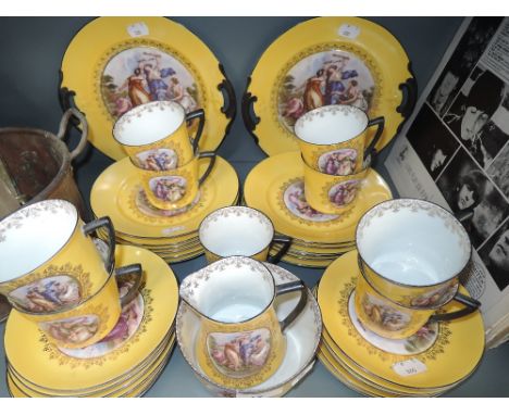 A part tea service in yellow and black design with classical print
