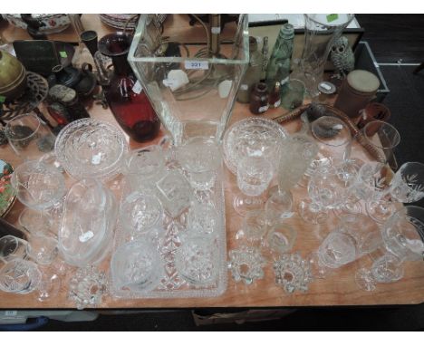 A selection of clear cut and crystal glass wares including ruby red vase