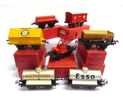 [O GAUGE]. SEVEN HORNBY WAGONS  comprising a Petrol Tank Wagon 'National Benzole'; Petrol Tank Wagon 'Esso'; Cement Wagon 'Po