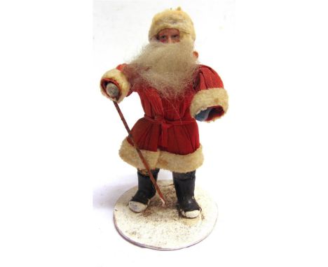 A BISQUE FATHER CHRISTMAS OR SANTA CLAUS DOLL  the head with painted facial features and a long white beard, on a compressed 