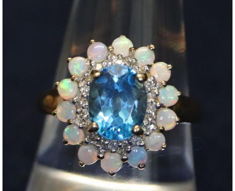 9ct gold blue topaz and opal ring. Approximate weight 4g. (B.P. 21% + VAT) size - P 1/2 blue stone is 0.9 x 0.7 mm Minor wear