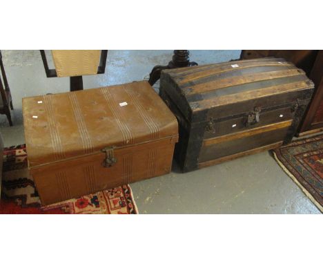 Vintage domed top trunk with wooden and metal banding and leather carrying handles, together with a vintage tin trunk. (2)(B.