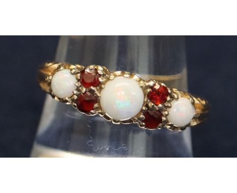 9ct gold opal and garnet ring.  Ring size R. Approximate weight 3.4g. (B.P. 21% + VAT) 