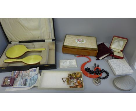 A collection of costume jewellery, a brush and mirror set lacking comb and a storage box 