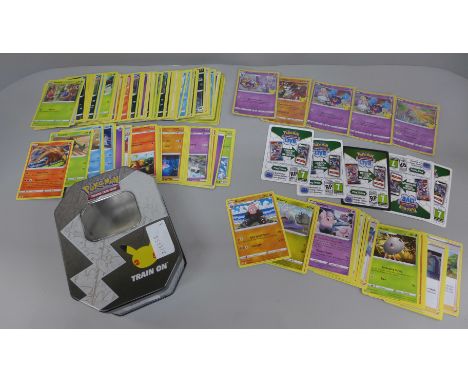 Pokemon cards; a Pokemon collectors tin containing 150 basic Pokemon cards and five holographic cards in protective sleeves a