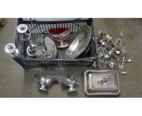 A silver plated six bottle cruet, a plated sugar basin with cranberry glass liner, a plated candelabra, vegetable serving dis