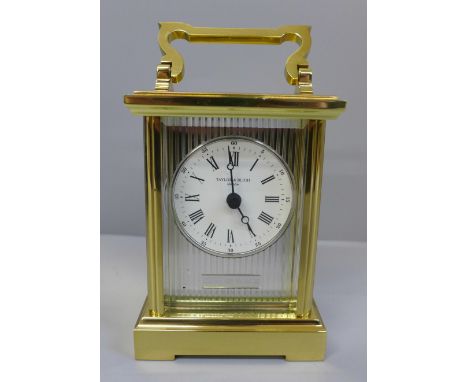 A silver fronted brass carriage clock with purchaser's receipt, boxed