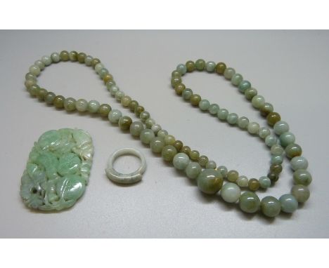 A jade necklace, carved jade and a ring 
