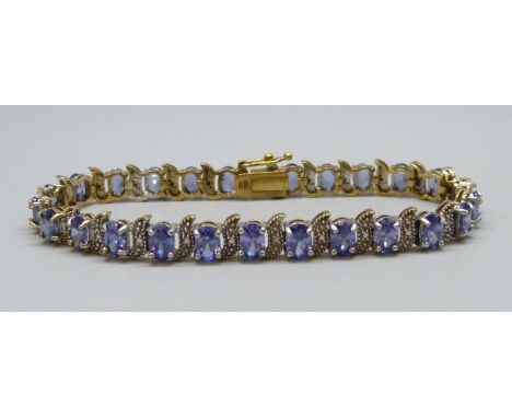 A silver gilt tanzanite tennis bracelet, 15g 