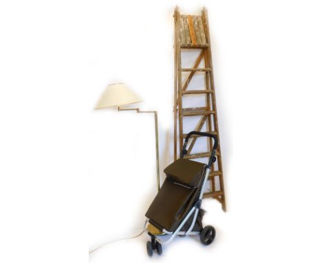A brass standard lamp, with modern cream shade, 148cm high, folding step ladder and a mobility shopping bag on wheels. (a qua