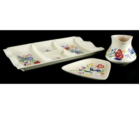 Three items of Poole pottery, to include a rectangular hors d'oeuvres tray, a tapering rectangular dish and a jug, each paint