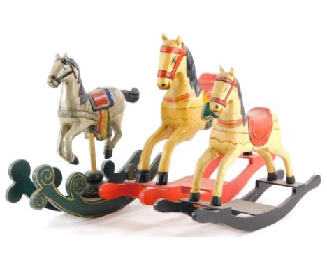 Three model miniature rocking horses, each with coloured enamel decoration, the largest 39cm long.